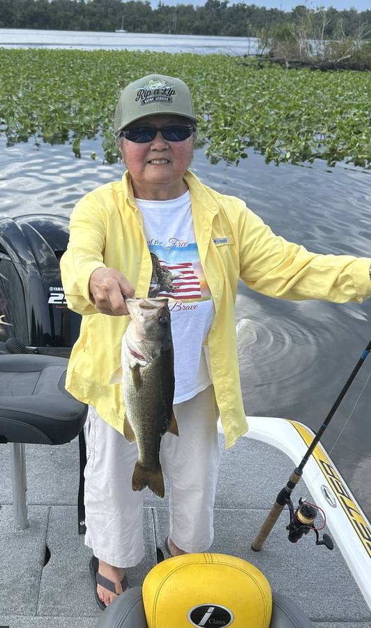 Angler in a Rip A Lip cap with a St. Johns River largemouth